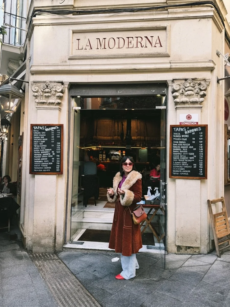Karen in a rust corduroy coat outside La Moderna, a tapas bar in Europe